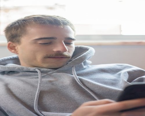 Persona usando su smartphone relajada en casa